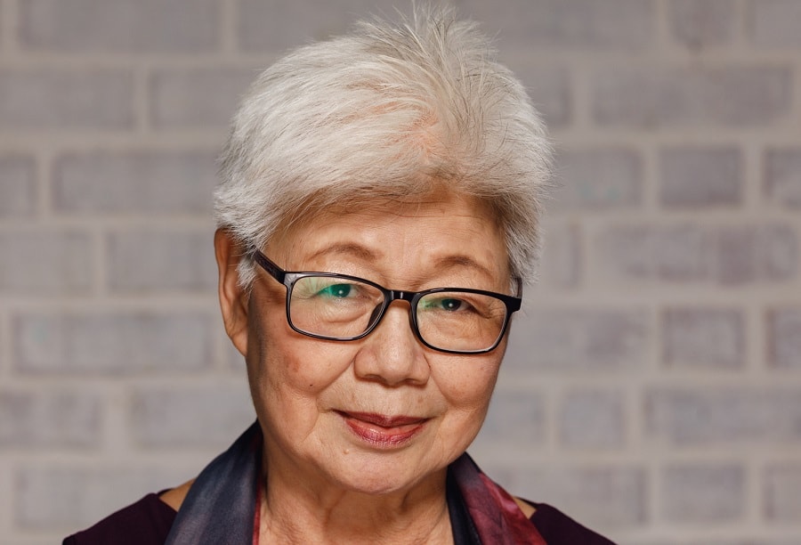 Asian woman over 70 with short hair and glasses