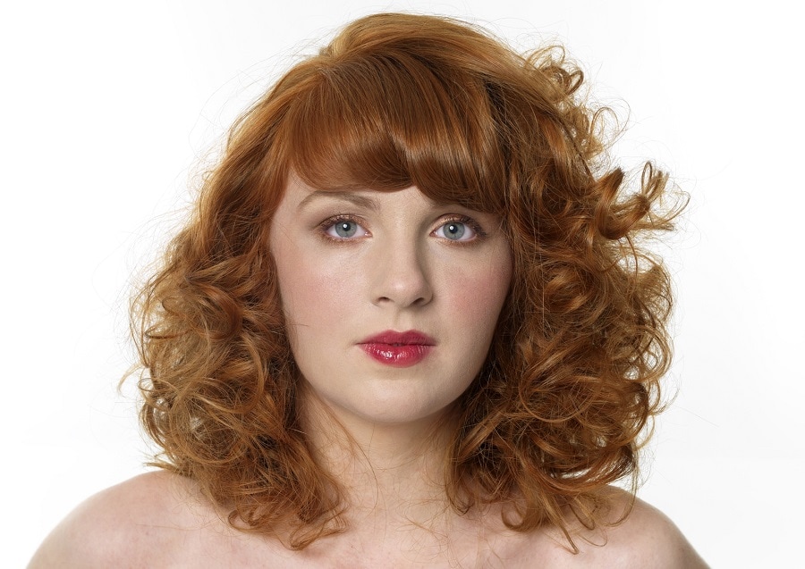 auburn perm hair with thick bangs