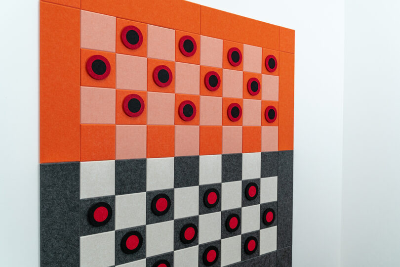 orange, pink, white, and grey felt checkers game