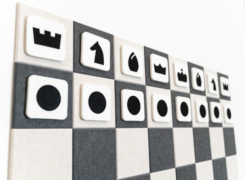 dark grey and white felt checkers game