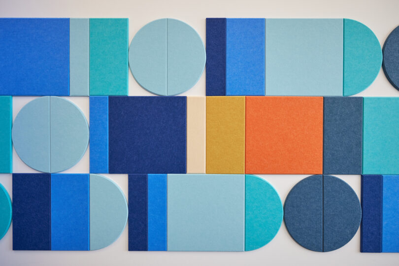 mustard, orange, light blue, cyan, dark blue, and cream acoustic wall tiles