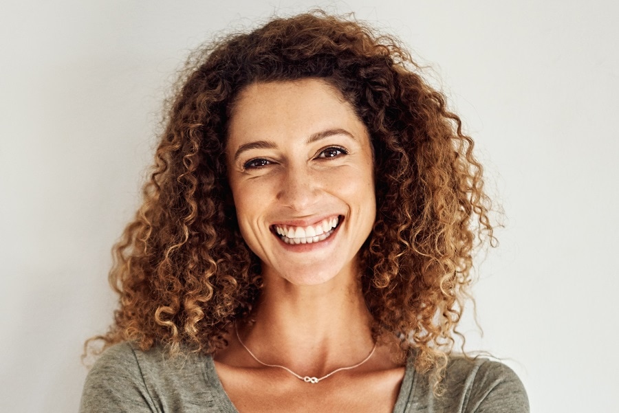 curly-dark-chestnut hair with highlights