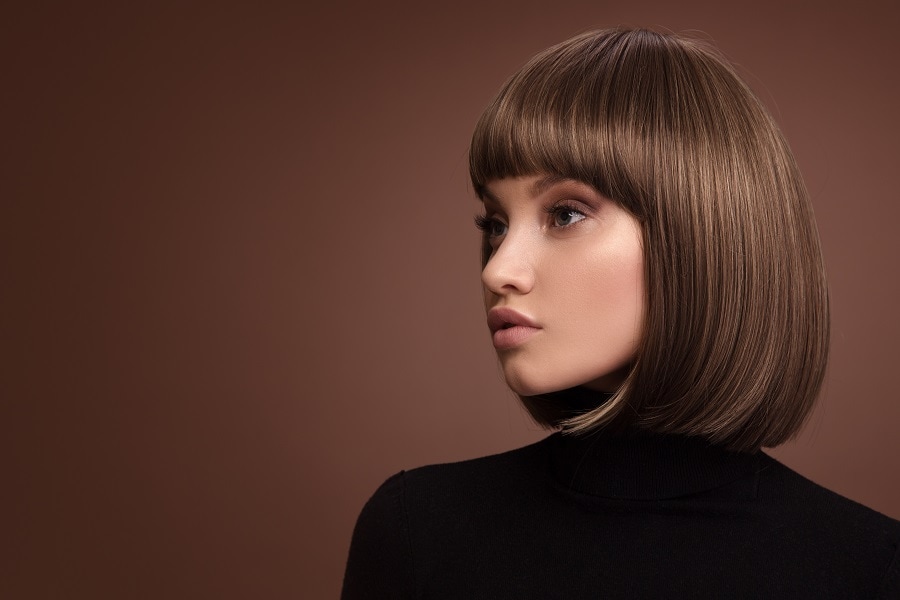 sleek dark brown bob with thick bangs