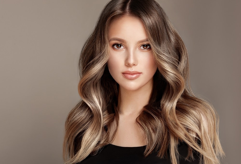 face framing highlights on long wavy hair