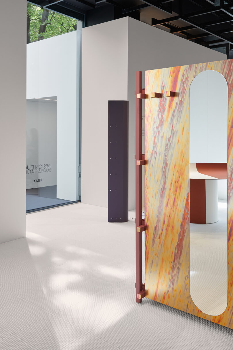Modern art gallery interior featuring abstract sculptures and installations with minimalist furniture and white walls.