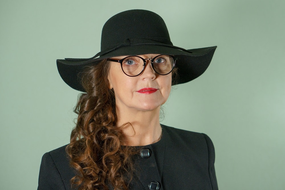 older woman with long curly hair