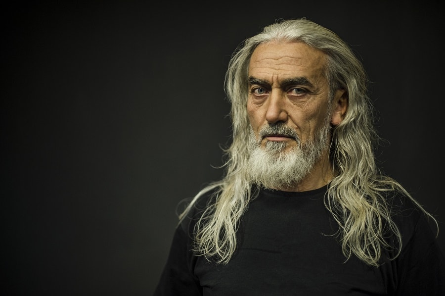 older man with blonde long hair