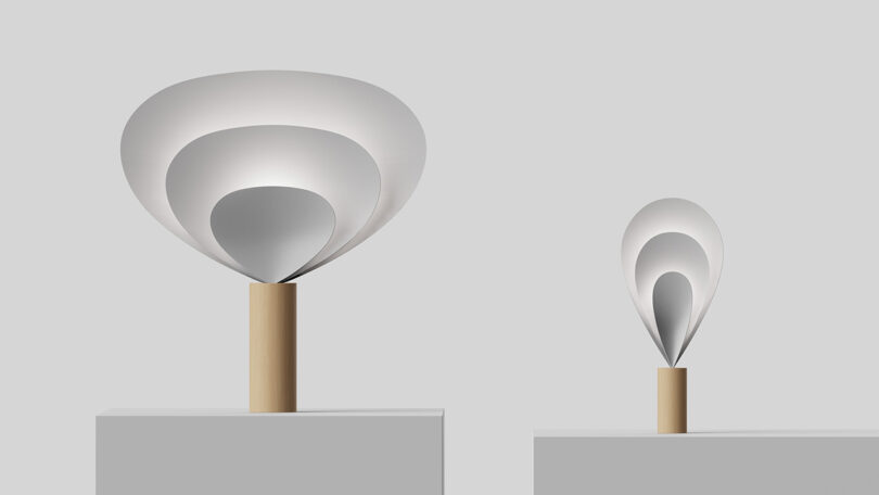 SWNA's Drop Light in small and large sizes, each design comprised of three parabolic forms gathered into a fan-like shape nested into one another and held together by a cylindrical wood base.