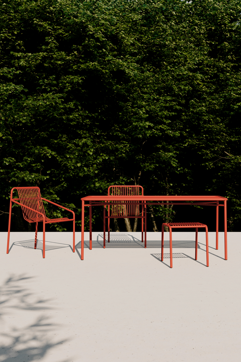 Modern red outdoor furniture casting shadows in sunlight.